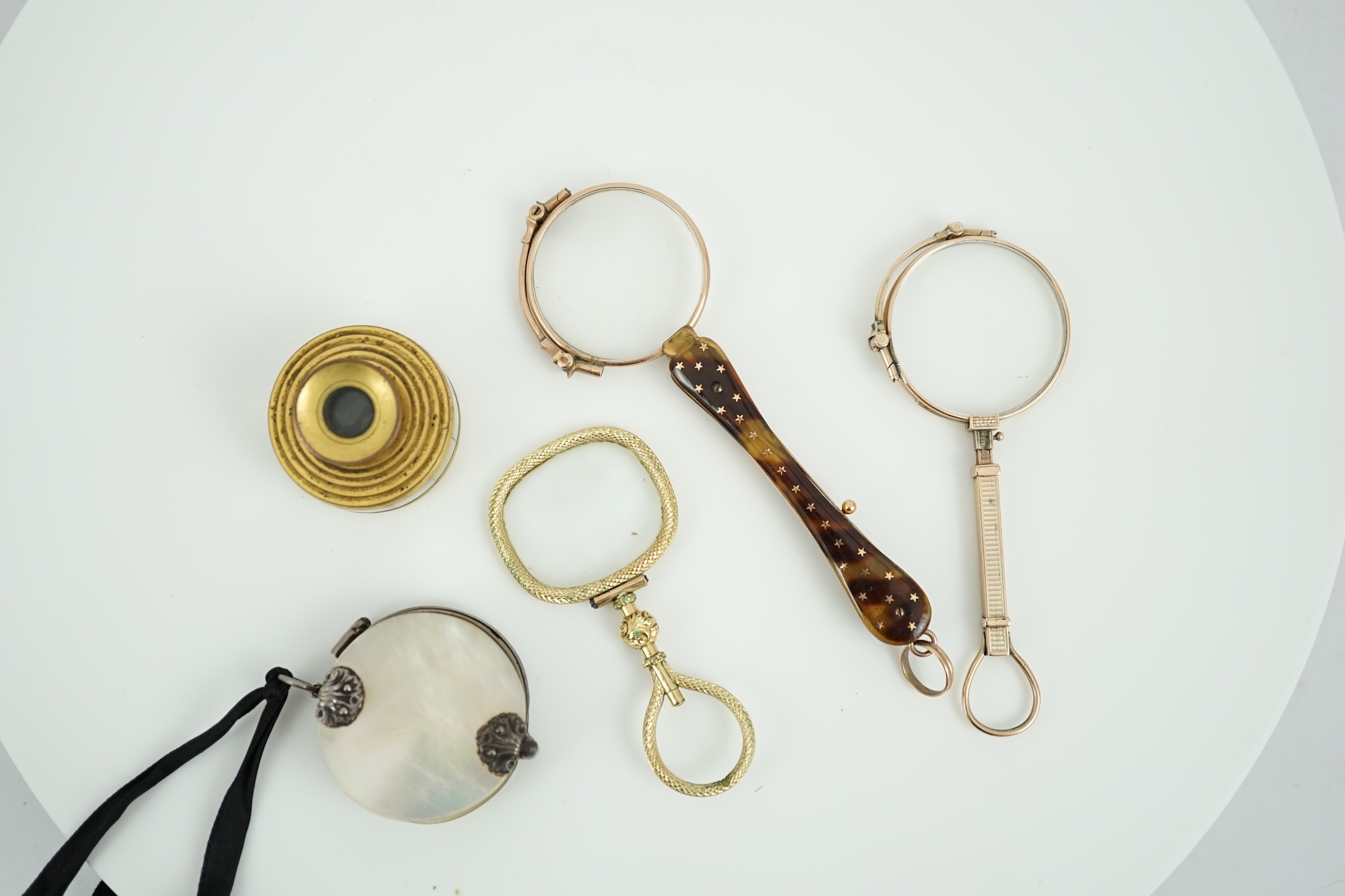 A 19th century mother of pearl and white metal mounted folding double magnifying glass, 40mm, two yellow metal mounted lorgnettes including Hamblin, London, a spy glass and a mother of pearl mounted gilt metal monocular.